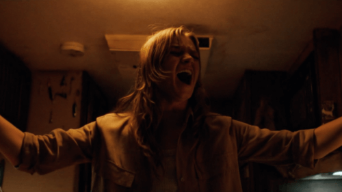 Girl screaming in a dark hallway.